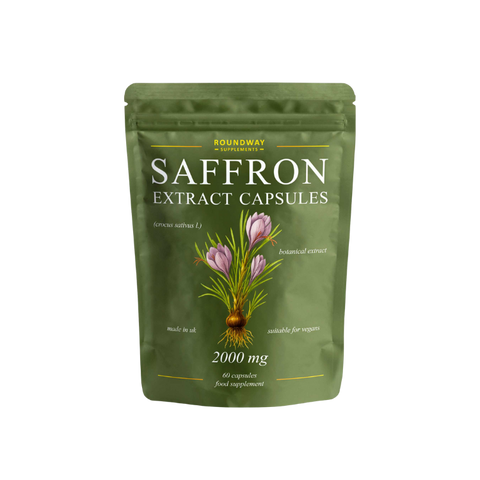 Green package of saffron extract capsules on a white background